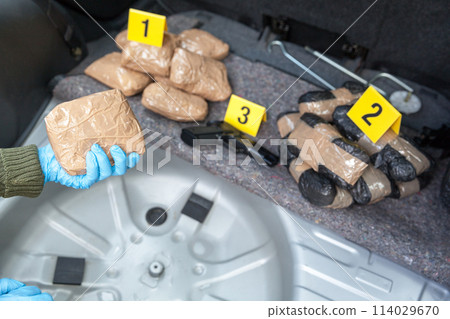 Drug smuggling in the trunk of a car Drug smuggling in the trunk of a car 114029670