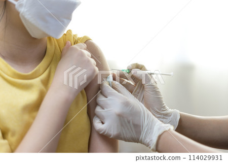 Asian Preteen Girl Getting Vaccinated, Receiving Coronavirus Vaccine Injection in clinic. Asian Preteen Girl Getting Vaccinated, Receiving Coronavirus Vaccine Injection in clinic. 114029931