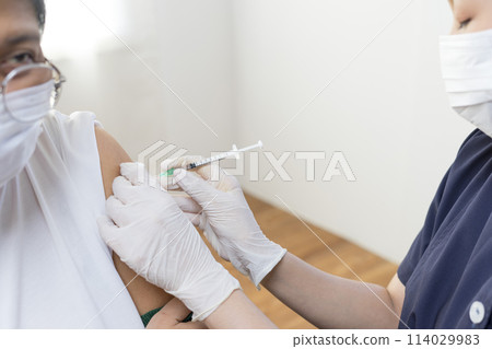 Elderly Asian woman getting coronavirus vaccine by nurse. Medical worker prepare syringe. Elderly Asian woman getting coronavirus vaccine by nurse. Medical worker prepare syringe. 114029983