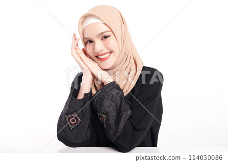 Beautiful young asian muslim woman wearing a beige hijab on white background, Portrait of Arab Beauty. 114030086