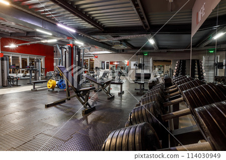 Exercise equipment in an empty gym Exercise equipment in an empty gym 114030949