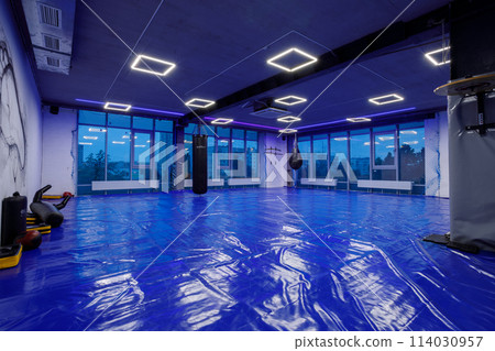 Exercise equipment in an empty gym 114030957