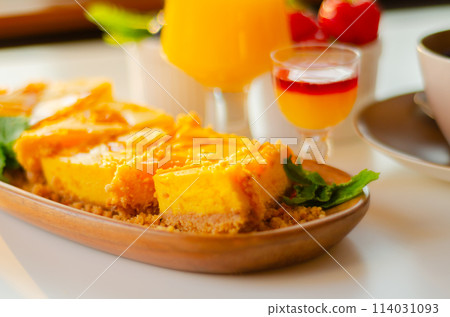 Baked vanilla and tropical flavour cheesecake swirled with passion fruit sauce on a digestive biscuit crumb Baked vanilla and tropical flavour cheesecake swirled with passion fruit sauce on a digestive biscuit crumb 114031093