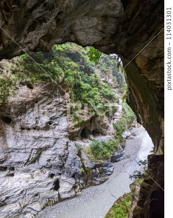 Taroko, Taiwan - 11.26.2022: Viewing swallow hollows and potholes on marble cliffs along Liwu River from Swallow Grotto Trail under sunlight on a rainy day before 403 earthquake during the pandemic 114031301
