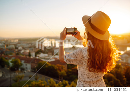 Travel in Europe. Young woman enjoys sunrise. The concept of travel, tourism, vacation and freedom. 114031461