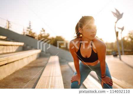 Fit Young woman in sportswear doing yoga, fitness exercise on the street. Sport, Active life. 114032110