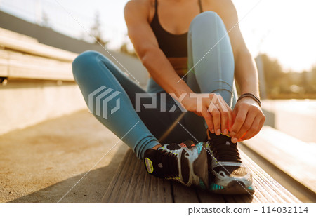 Fit Young woman in sportswear doing yoga, fitness exercise on the street. Sport, Active life. 114032114