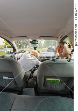 Couple in car, man fixing interior Couple in car, man fixing interior 114032436