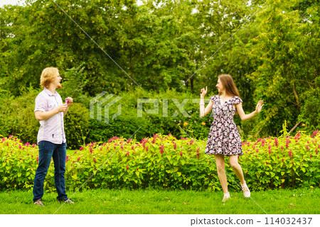 Couple blowing bubbles outdoor Couple blowing bubbles outdoor 114032437