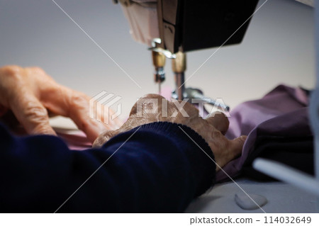 Craftsman using a sewing machine 114032649