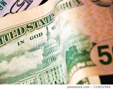 Financial Focus. Close-up of US dollars, Capitol building, and motto. Uses for Financial articles, economic education. Financial Focus. Close-up of US dollars, Capitol building, and motto. Uses for Financial articles, economic education. 114032968