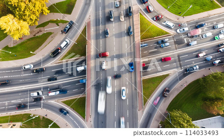 Congestion at an intersection during rush hour, aerial view, blurred motion of moving cars Congestion at an intersection during rush hour, aerial view, blurred motion of moving cars 114033493