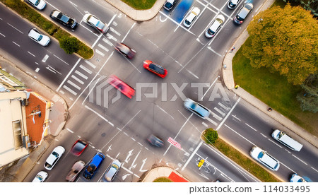 Congestion at an intersection during rush hour, aerial view, blurred motion of moving cars Congestion at an intersection during rush hour, aerial view, blurred motion of moving cars 114033495
