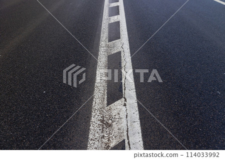 old road markings on the highway in winter 114033992