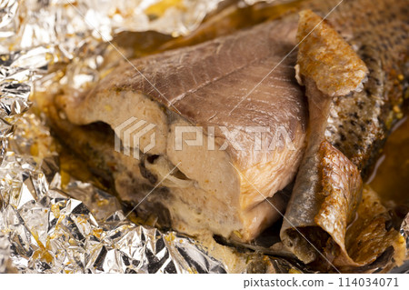 red trout fried in foil with spices, close-up red trout fried in foil with spices, close-up 114034071