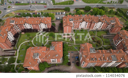 Modern urban housing. Top view of the city San Giuliano Milanese. Drone view of houses and streets on a spring day. Milan, Lombardy, Italy. 114034076