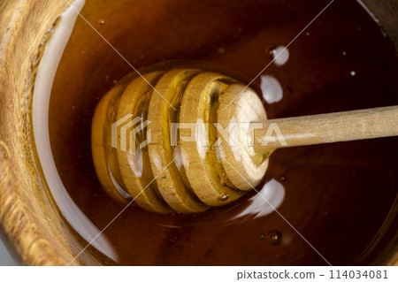 real bee honey from pollen flowers in a wooden bowl on the table 114034081