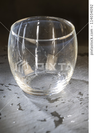 dirty transparent glass on a black slate board dirty transparent glass on a black slate board 114034092