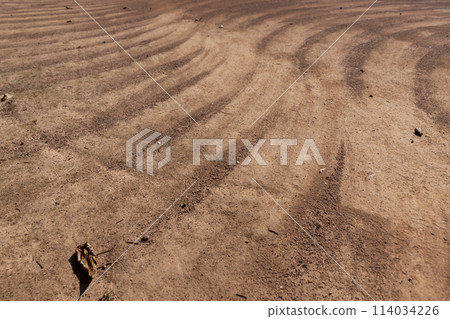 a walking red path made of rammed sand after sweeping a walking red path made of rammed sand after sweeping 114034226