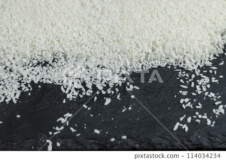 dry white coconut chips for adding to desserts 114034234