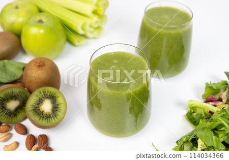 Healthy vegetable smoothie in glasses on white background. 114034366