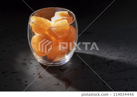 grapefruit juice with ice in a glass on a black background 114034448