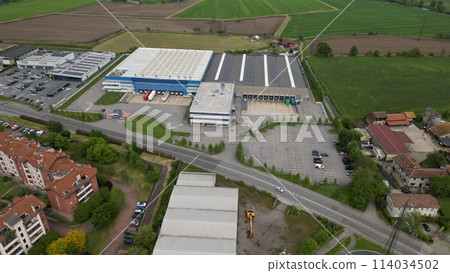 Aerial view Industrial zone. Top view of the city San Giuliano Milanese. Drone view of houses and streets on a spring day. Milan, Lombardy, Italy 114034502