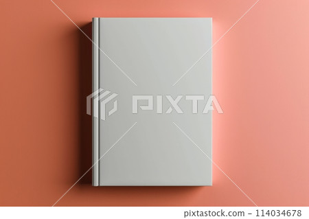 a mockup with a blank white book cover against a peach colored background 114034678