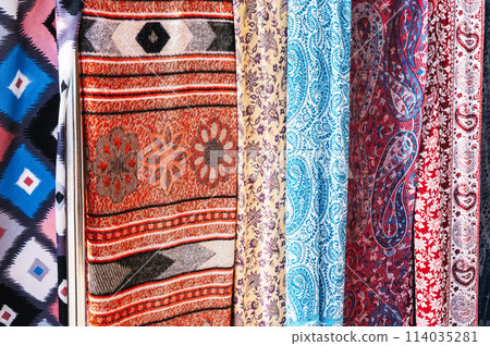 Traditional silk Indian scarves with a bright colorful pattern closeup 114035281
