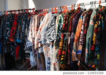 Traditional Asian dresses with bright colored pattern at the oriental bazaar in Asia 114035309