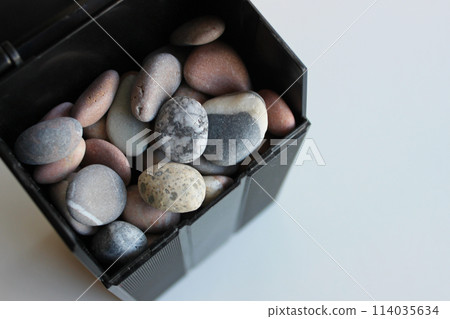 Model Of Black Can With Round River Rocks Closeup Top View Model Of Black Can With Round River Rocks Closeup Top View 114035634