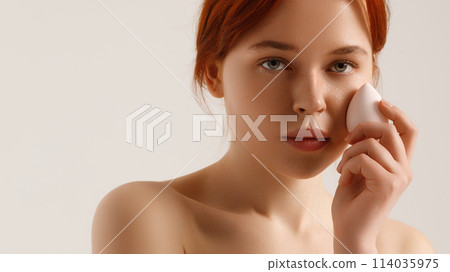 Nude makeup. Beautiful young girl applying face Nude makeup. Beautiful young girl applying face 114035975