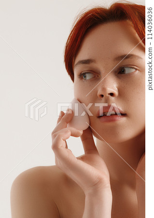 Nude makeup. Beautiful young girl applying face Nude makeup. Beautiful young girl applying face 114036036