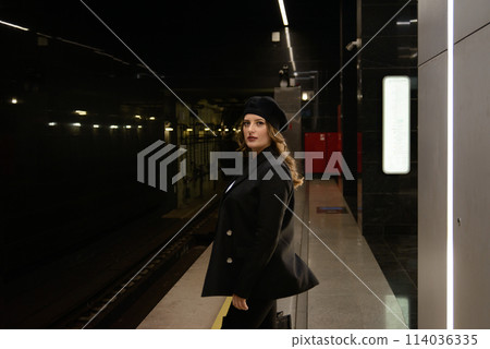 Beautiful lonely girl in black posing in the subway. Beautiful lonely girl in black posing in the subway. 114036335