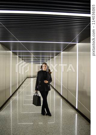 Beautiful lonely girl in black posing in the subway. 114036865