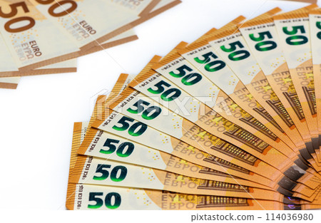 close-ups of a fan of 50 Euro bank notes isolated over white background. close-ups of a fan of 50 Euro bank notes isolated over white background. 114036980