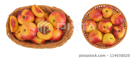 Ripe nectarine fruit with half in a wicker basket isolated on white background with full depth of field. Top view. Flat lay 114038020