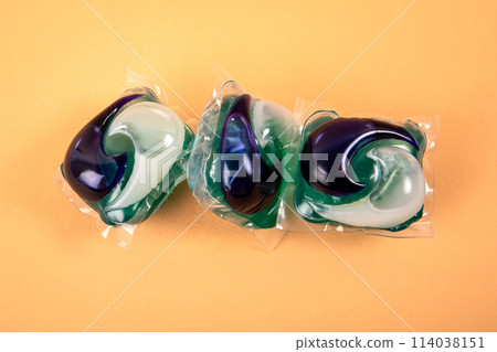 Laundry capsules in a pile on a light background Laundry capsules in a pile on a light background 114038151