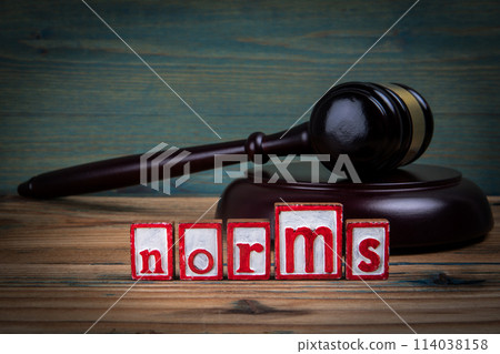 NORMS. Red alphabet letters and judge's gavel on wooden background. Laws and justice concept NORMS. Red alphabet letters and judge's gavel on wooden background. Laws and justice concept 114038158