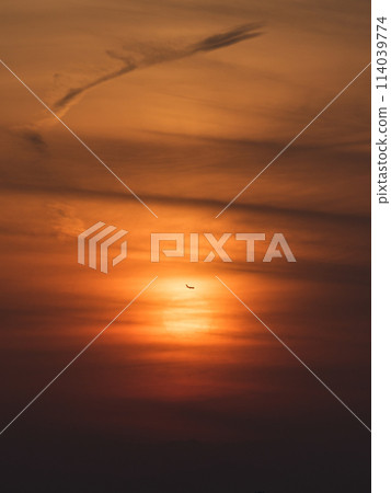 Sunset and silhouette of an airplane 114039774