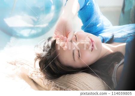 A beautiful woman lying down in the dazzling summer sunshine with her eyes closed. Also great for beauty images of the beach, summer tans, and UV rays. A beautiful woman lying down in the dazzling summer sunshine with her eyes closed. Also great for beauty images of the beach, summer tans, and UV rays. 114039805