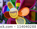 A colorful pinwheel with happy on the front 114040288