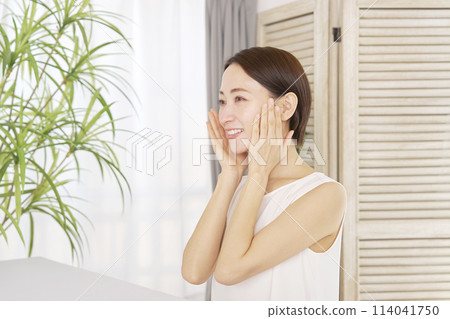 Middle-aged woman doing facial care at home 114041750