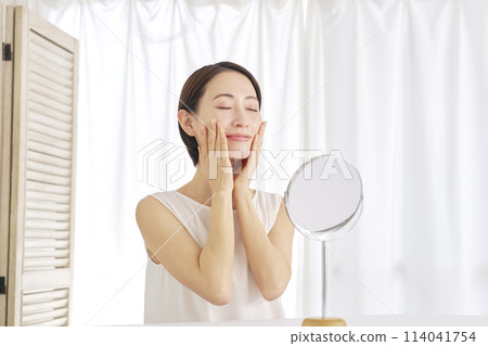 Middle-aged woman doing facial care at home Middle-aged woman doing facial care at home 114041754