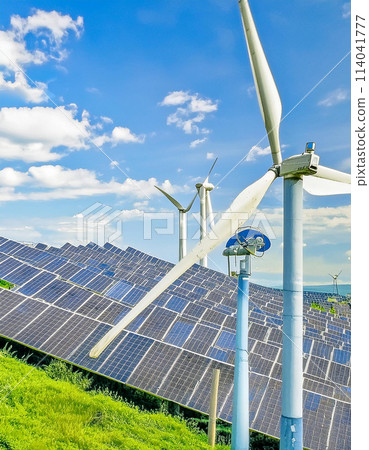Windmills and solar panels against the blue sky 114041777