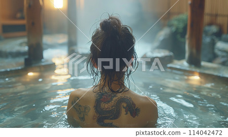 Tattooed woman in hot spring 114042472