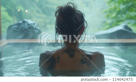 Tattooed woman in hot spring 114042473