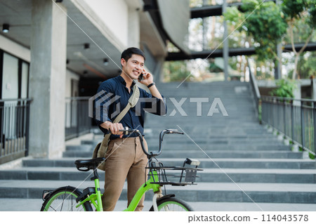 asian young businessman use smart phone while commuting in city. Eco friendly 114043578
