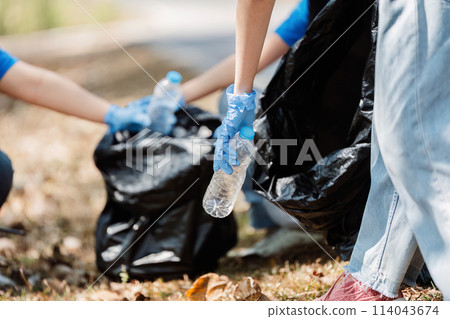 Group of volunteers, community members cleaning the nature from garbage and plastic waste to send it for recycling Group of volunteers, community members cleaning the nature from garbage and plastic waste to send it for recycling 114043674