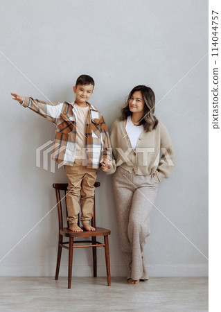 A mother and her son are hugging and smiling A mother and her son are hugging and smiling 114044757